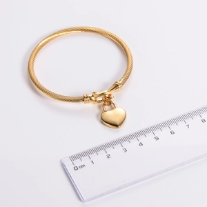 18k gold plated stainless steel cable bracelet with heart pendant on white background