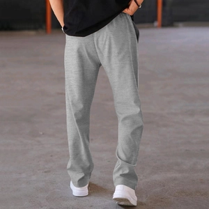 Detail of men's grey knitted straight-leg sweatpants featuring an elastic waistband and soft fabric