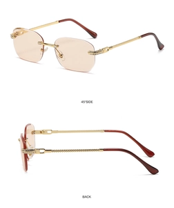Detail view of gold metal temples with rhinestone accents on rimless sunglasses