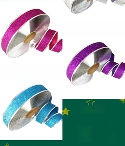 Detalle de cintas navideñas con purpurina en rosa, púrpura y azul para decorar el árbol