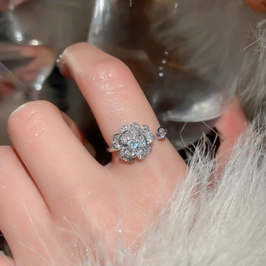 Detail of silver flower ring with sparkling pave cubic zirconia petals on hand