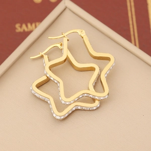 Exaggerated golden star-shaped earrings with sparkling rhinestone studs and side zircon inlay