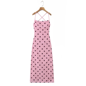 Detail of pink polka dot long dress showing thin cross straps on the open back