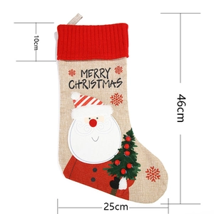 Detail view of a 46cm linen Christmas stocking with Santa Claus and tree embroidery