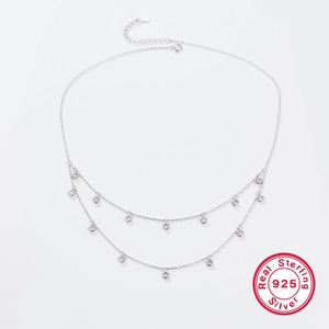 Double layer 925 sterling silver necklace with zircon pendants on a white background