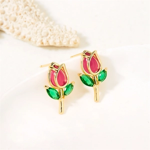 Detail of pink tulip earrings with gold leaves and green crystal inlay on white background