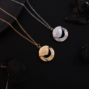 Vintage stainless steel floating locket necklace with round embossed scrolls in gold and silver
