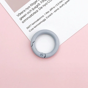 Detail shot of light blue metal spring ring buckle on a decorative card background