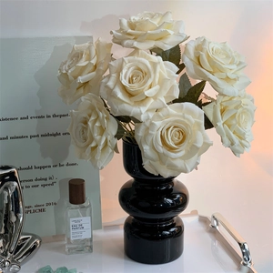 Artificial cream rose bouquet in black glossy ceramic vase for elegant home table decor