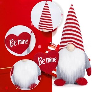 Detail of knitted Valentine gnome with striped hat and Be Mine heart ornament