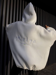 Detail view of Mriya letter embroidery on the back of white oversized cotton hoodie