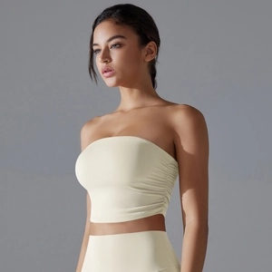 Detail view of cream ruched tube top and high waist leggings for yoga and fitness