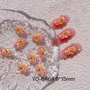 Macro shot of 9x15mm seahorse nail art charms with colorful ocean gradient finish