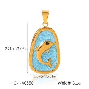Detail of oval gold dolphin pendant with sky blue ripple texture and metal clasp