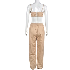 Detail view of khaki two-piece set featuring back zipper crop top and elastic waist pants