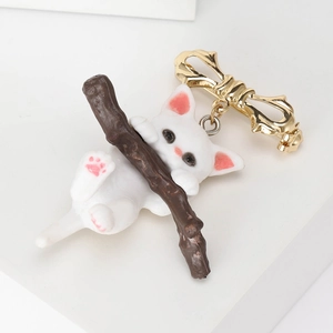 Cute white cat on branch enamel brooch with a golden bow pin for stylish women
