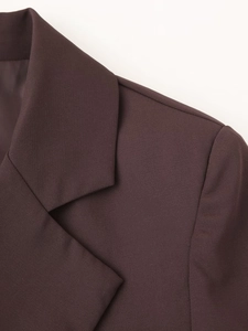 Close-up of lapel and shoulder details on a dark brown woven fabric blazer for women