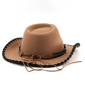 Detail of western felt cowboy hat with stitched brim and leather band with metal beads