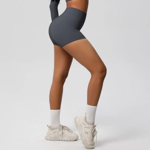 Detail view of high-waisted seamless dark grey yoga shorts with body-shaping effect