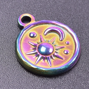 Macro detail of 18k gold plated sun and moon engraving on rainbow stainless steel pendant