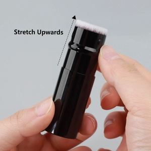 Detail of portable flat top foundation brush with retractable mechanism and soft bristles