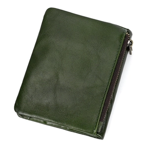 Close-up of dark green oil wax leather wallet texture with metal zipper detail