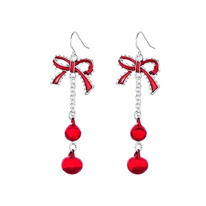 Close-up of Christmas earrings with red bows and double spheres on silver hooks