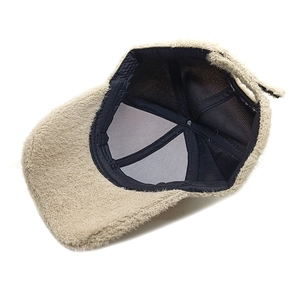 Inside view of a plush beige winter baseball cap with warm lining and adjustable strap