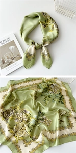Detail of light green floral silk scarf tied elegantly with decorative vintage patterns