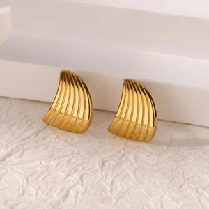 Detail of gold-plated stainless steel stud earrings with fan-shaped striped texture