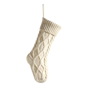 Classic cream white knitted Christmas stocking with diamond cable knit pattern on white background