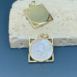 Golden square frame pendant with mother of pearl angel carving on beige stone
