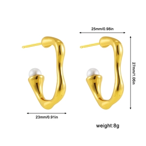 Detail view of gold wave earrings with white pearls and size specs 27mm height and 8g weight