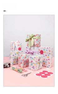 Macro view of colorful polka dot and star gift wrap with matching ribbons and stickers