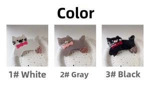 Detailed view of three cat-shaped hair claws with colorful glitter and bow tie accents