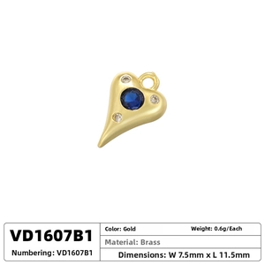 Macro shot of gold brass heart pendant with blue stone and size specifications