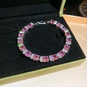 Detail of pink princess-cut zircon bracelet with silver chain in black jewelry box