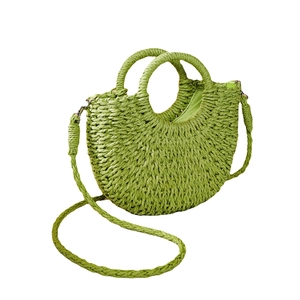 Handwoven grass green half-moon straw handbag with top handles and adjustable shoulder strap