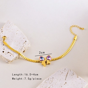 Detail of gold bow bracelet with purple crystal on white stone, 16.5+4cm length