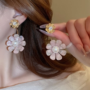 Elegant floral stud earrings with pink resin petals, white pearls, and sparkling zircons