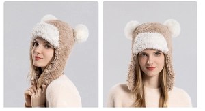 Detailed view of women's winter faux fur hat with plush pom-poms and ear protection