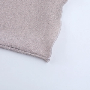 Macro shot of shimmering lavender knit fabric with fine silver glitter and hem details