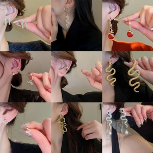 Vintage gold snake earrings set with crystal rhinestones and enamel drop finish