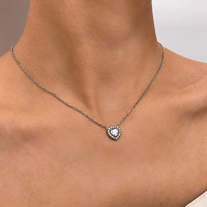 Elegant stainless steel heart necklace with cubic zirconia pendant worn by model