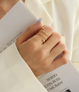 Detailed view of an 18K gold-plated double-layer spiral ring with bead accents on hand