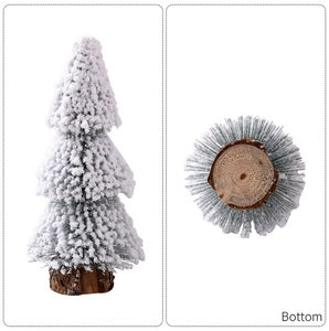 Detail view of mini snow-covered Christmas tree with rustic wooden base for table decor