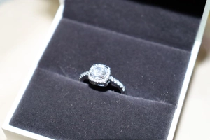 Macro view of square halo zircon ring with side stones in a velvet jewelry box