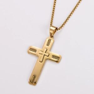 Detailed view of golden stainless steel cross pendant with Greek key pattern textures