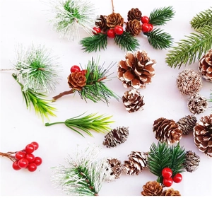Detail of pine cones, faux pine needles, and red berries for Christmas decoration