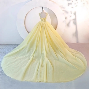 Elegant light yellow ball gown wedding dress with lace floral appliques and corset back